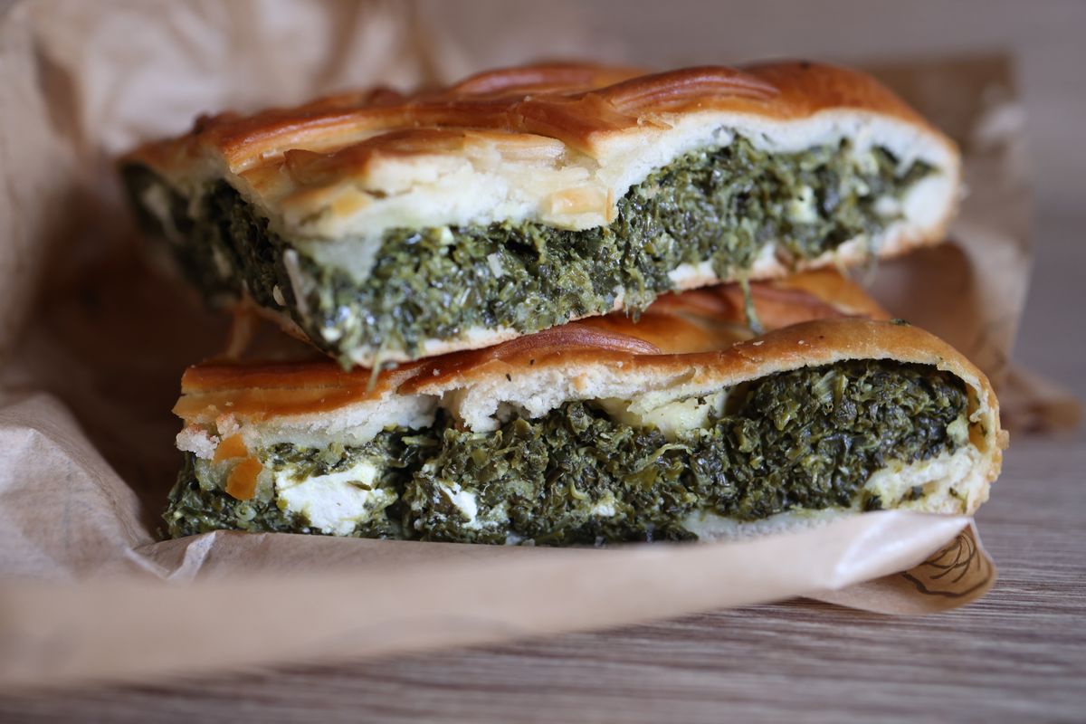 Slices of spinach and feta spanakopita, a Greek bakery snack