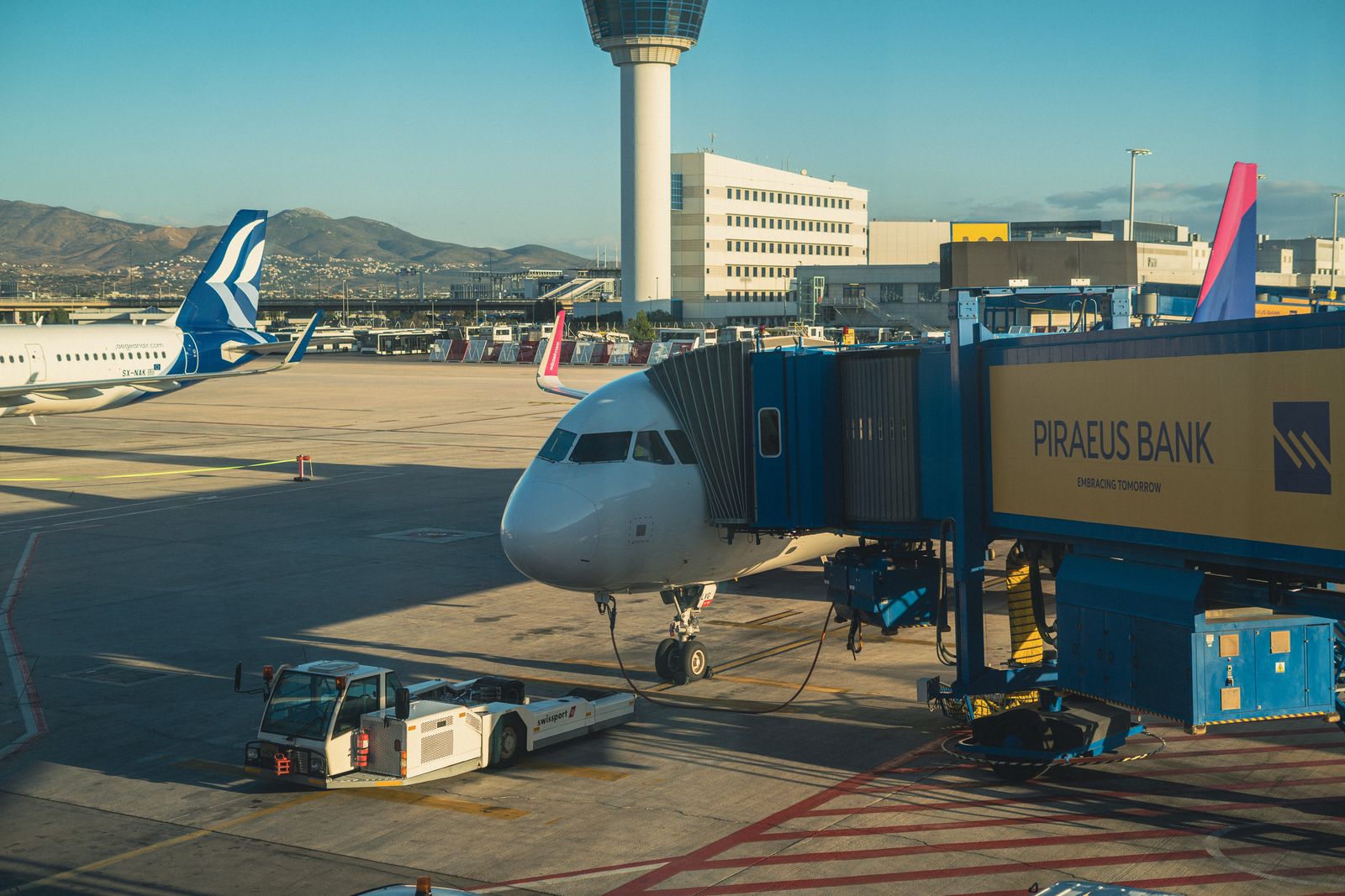 A passenger aircraft at a jet bridge at Athens International Airport