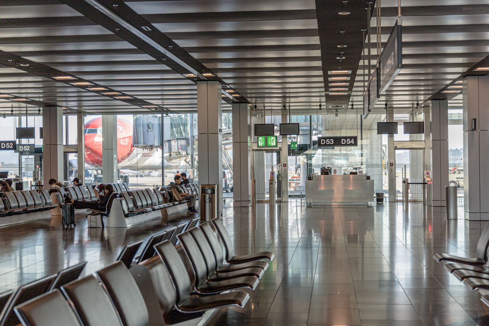 A calm, modern airport terminal seating area by the departure gates