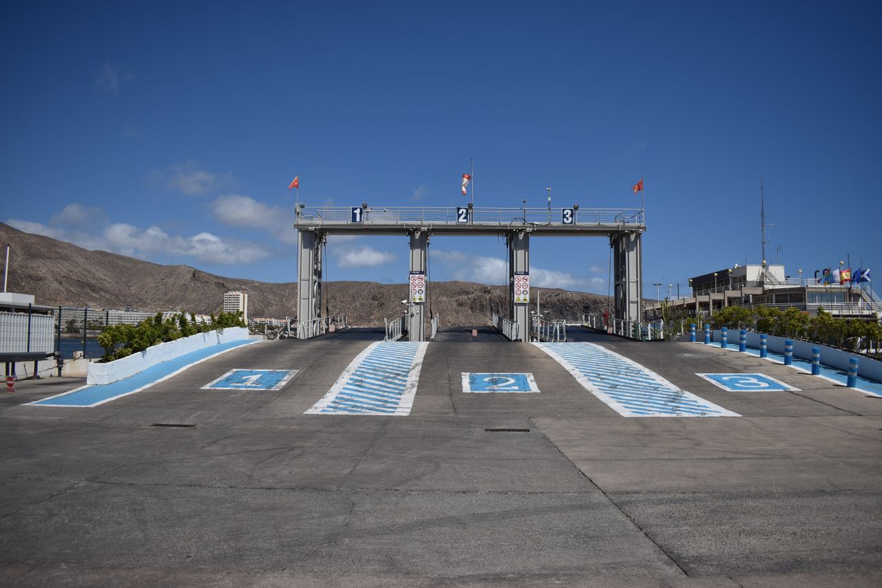Numbered vehicle boarding lanes at a Greek island ferry port