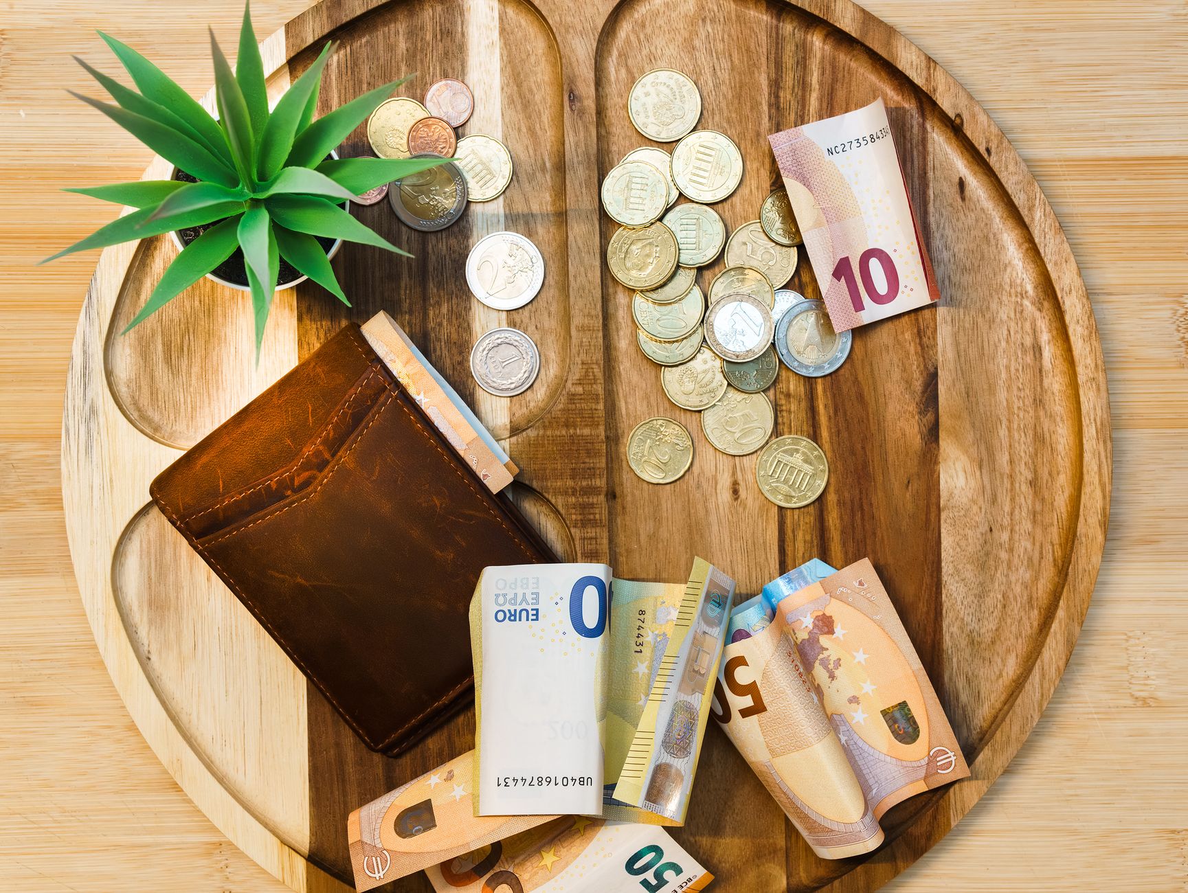 Euro banknotes, coins and a wallet ready for cash spending on Santorini