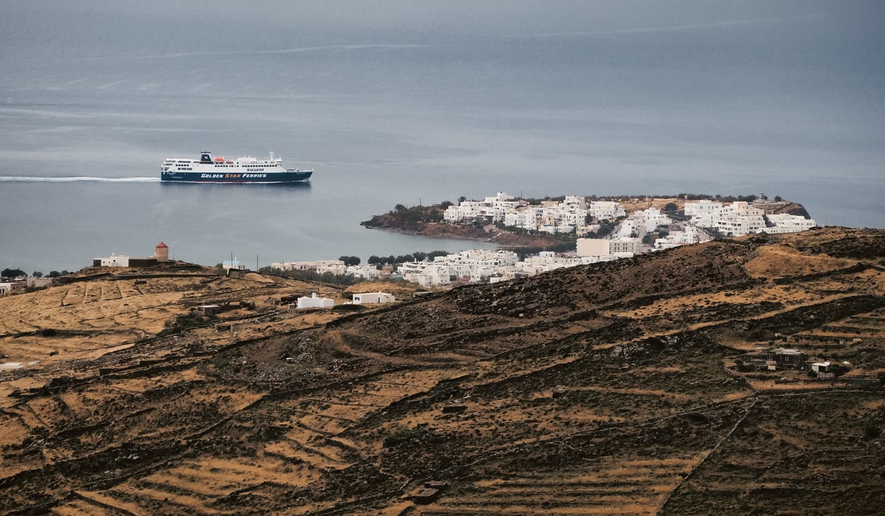 A ferry crossing the blue Aegean Sea between the Cyclades islands